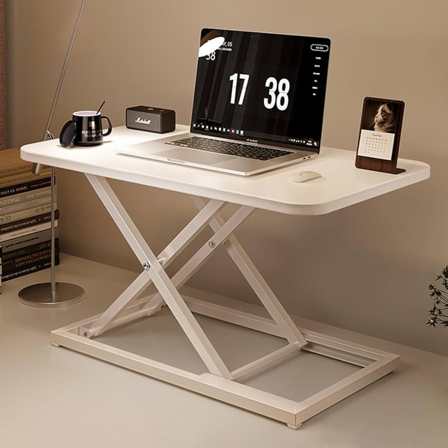 White sit-stand desk with laptop setup